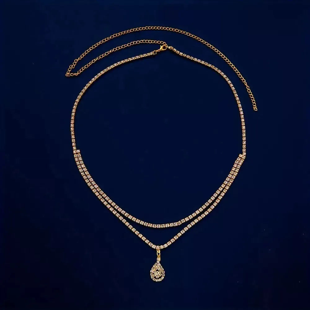 Gold rhinestone waist chain with tassel drop pendant and lobster clasp closure