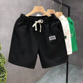 Men's casual sports shorts in polyester micro-elastic fabric available in white, black, or green