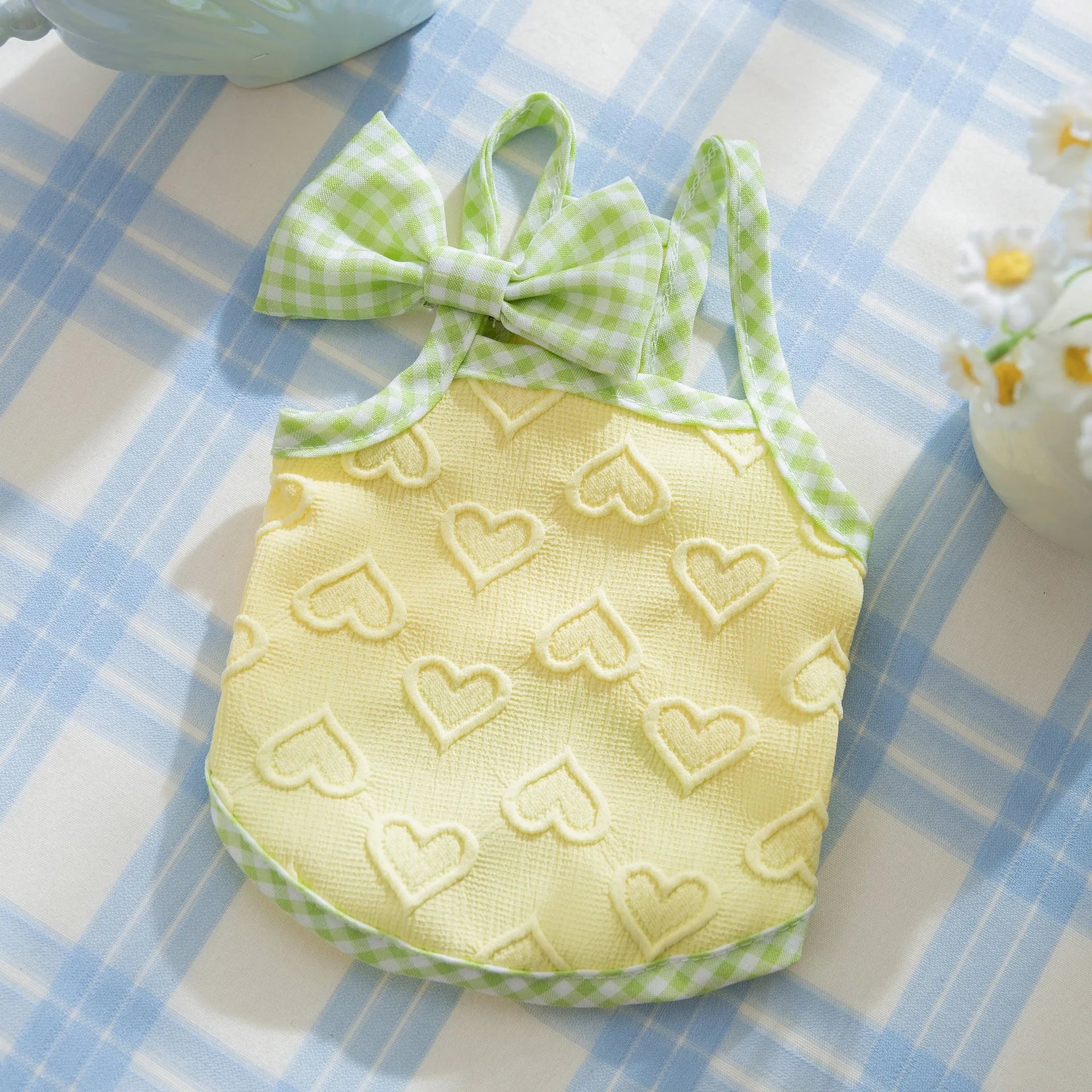 Small dog wearing heart texture elastic vest with bow suspenders in Bondi Blue colour