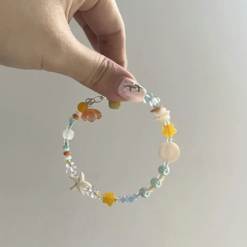 Orange water-soaked colour beach bracelet with diamond-shaped design and round elements