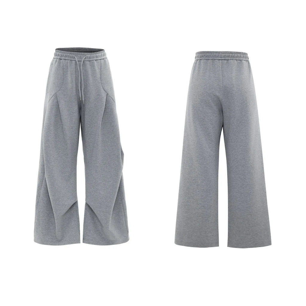 Men's dark grey cotton sports suit with metal embellishments, V-neck padded shoulders, short sleeves, and matching shorts