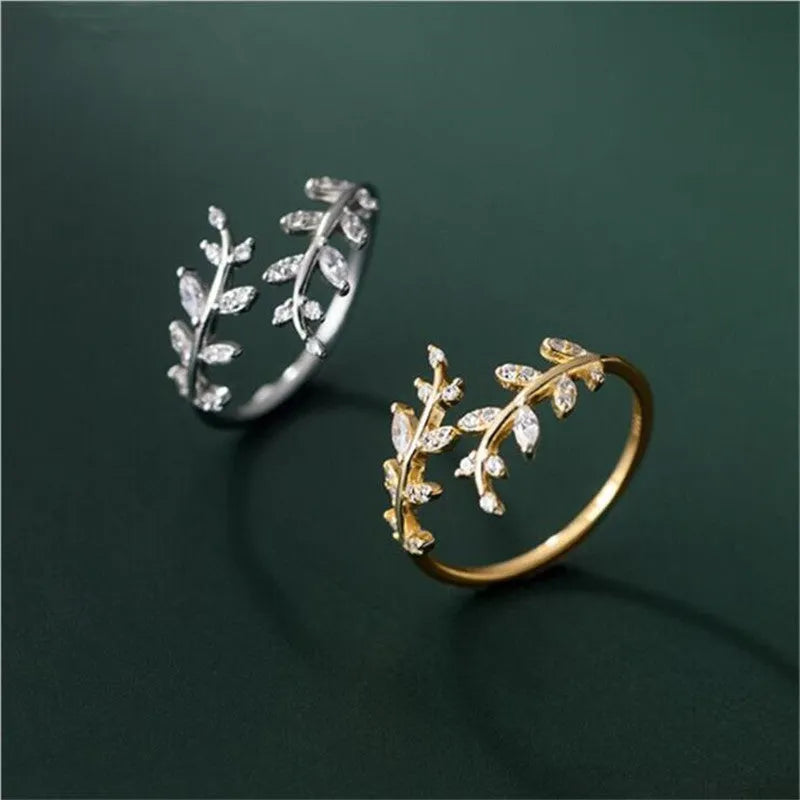 Gold and silver leaf-shaped branch ring for women on a white background.
