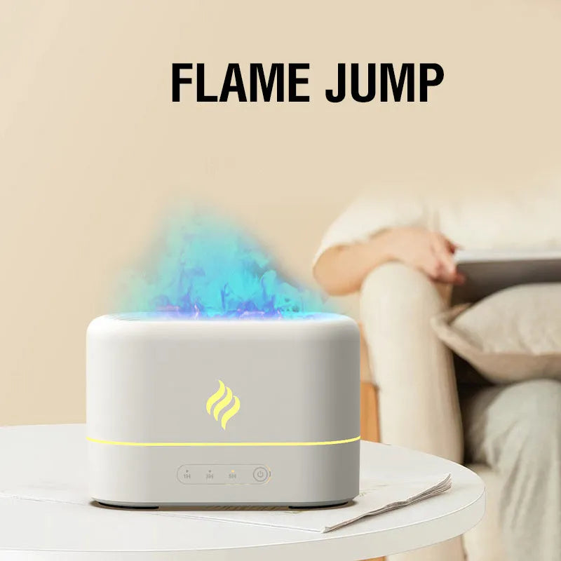 Black USB humidifier displaying a seven-colour flame effect on a desk next to a plant.