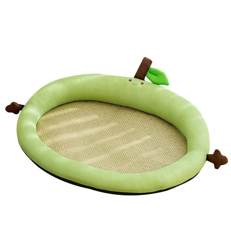 Green pet cooling mat with a raised fruit-shaped backrest, shown with a dog resting on it.