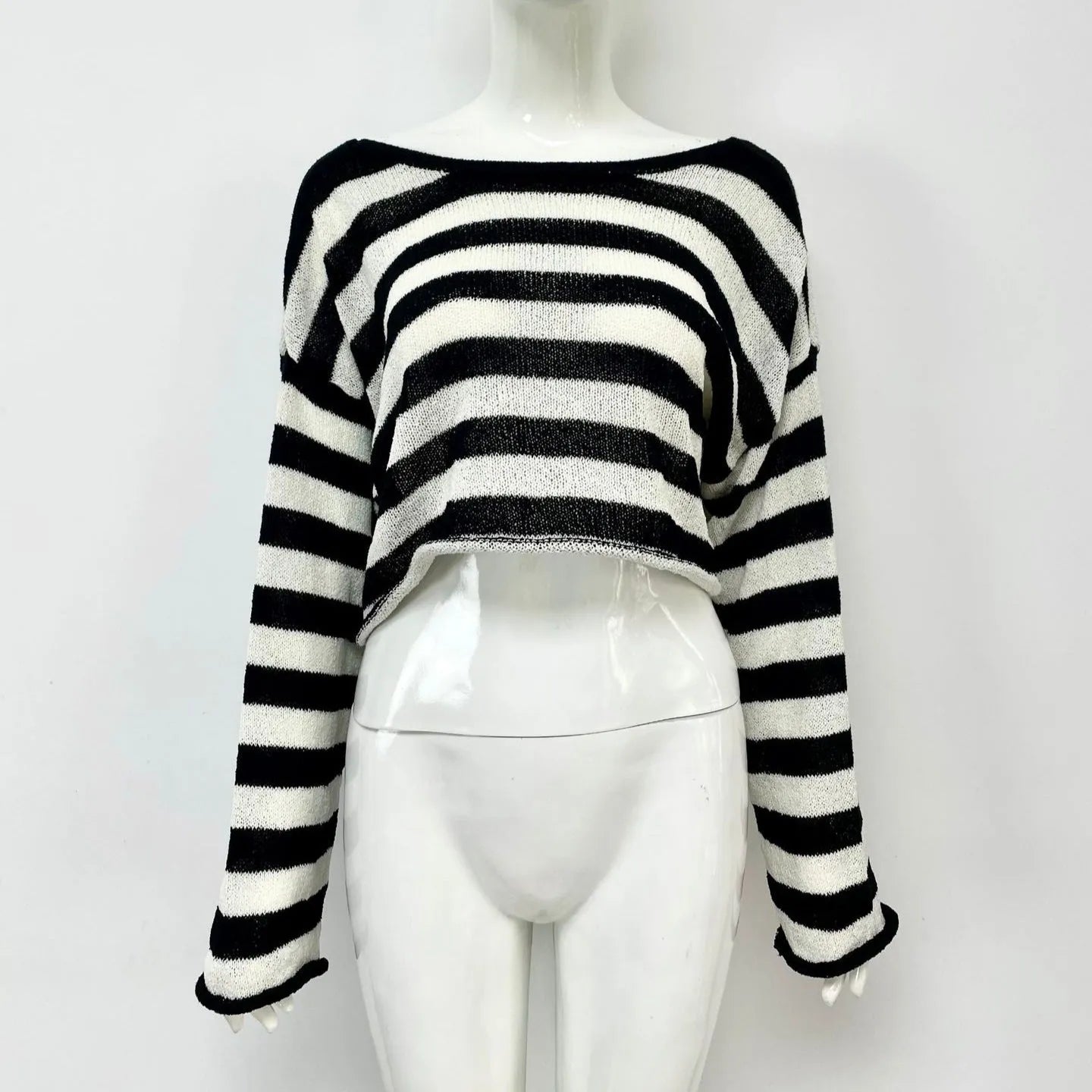 A striped long-sleeved pullover sweater with a cropped front and back design, shown in a selected colour.