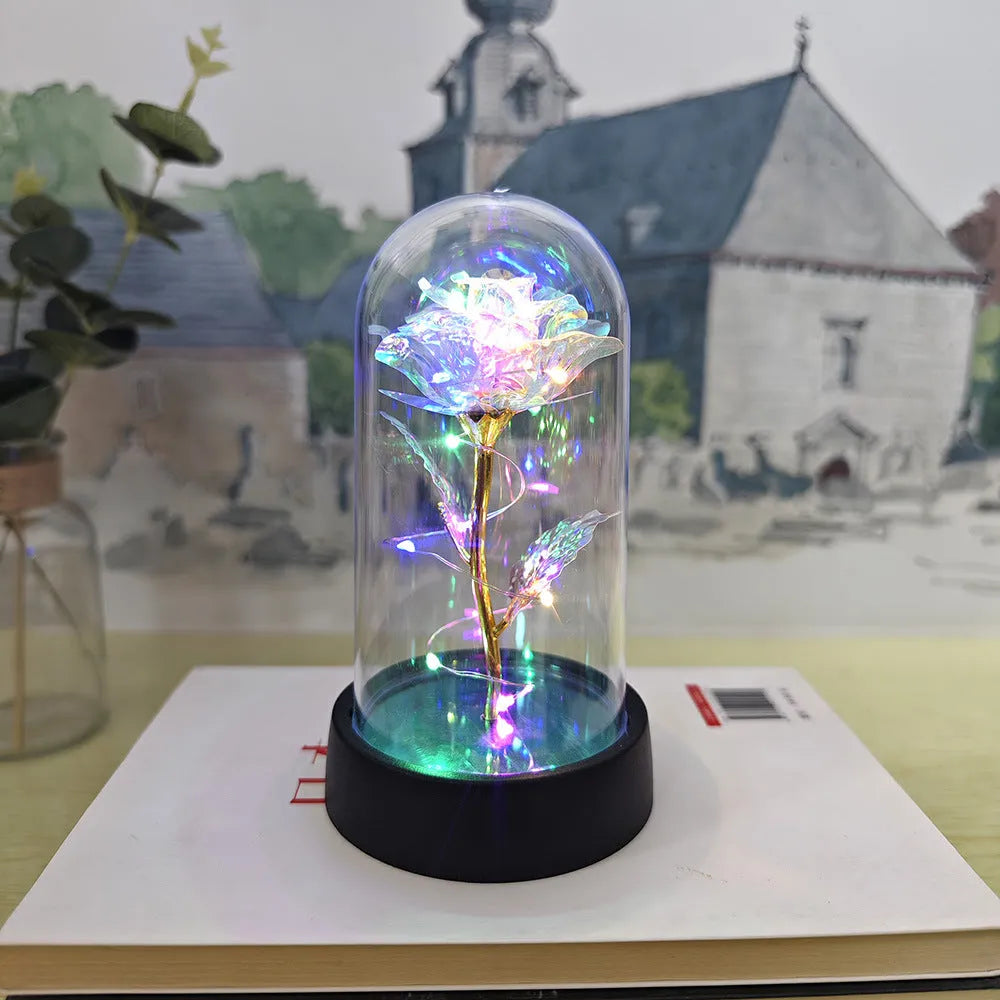 Small plastic night lamp with floral decoration and coloured light options on a black base.