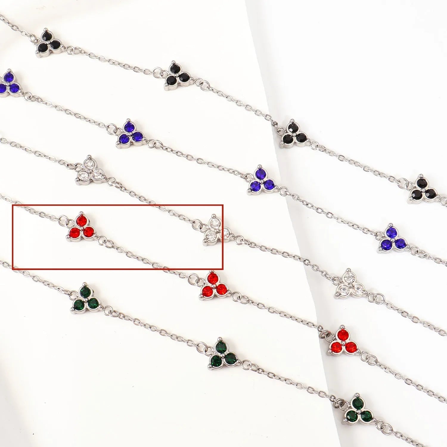 Women's stainless steel geometric triangle bracelet with a three-diamond pattern, shown in a gold and white zircon colour option.