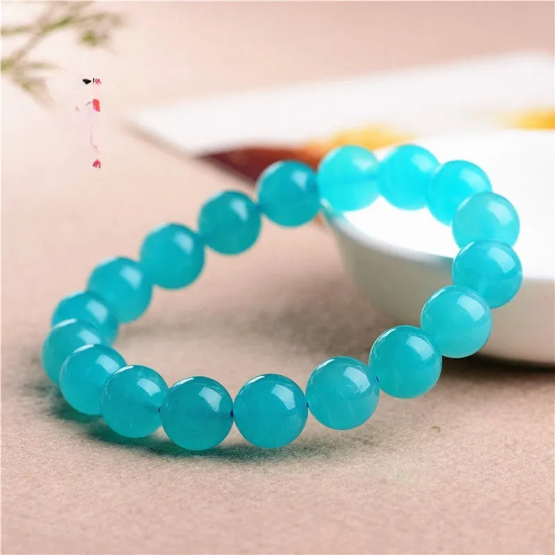Natural blue-green amazonite scattered beads bracelet on wrist, showing polished stones and single circle design.