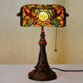 10-inch Tiffany desk lamp with coloured stained glass shade and resin base on a table.
