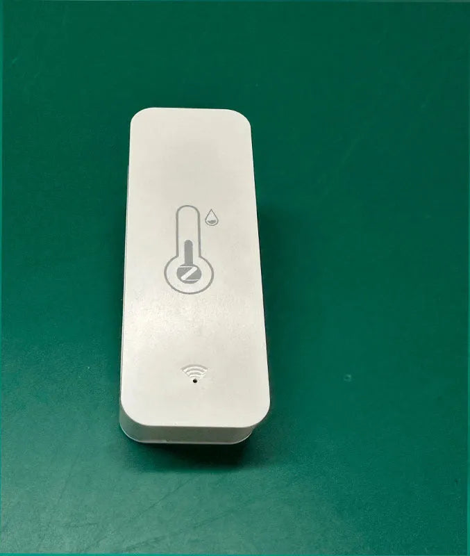 White WiFi and Zigbee smart temperature and humidity sensor on a table