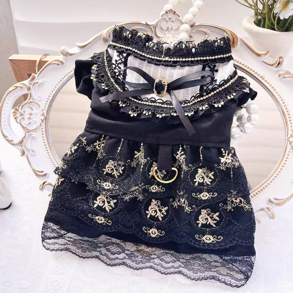 Golden gothic princess style polyester dress for a small dog on a mannequin, showing black skirt detail.
