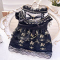 Golden gothic princess style polyester dress for a small dog on a mannequin, showing black skirt detail.