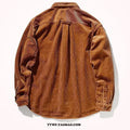 A man wearing a caramel coloured corduroy long sleeve cardigan shirt with a loose fit and button front.