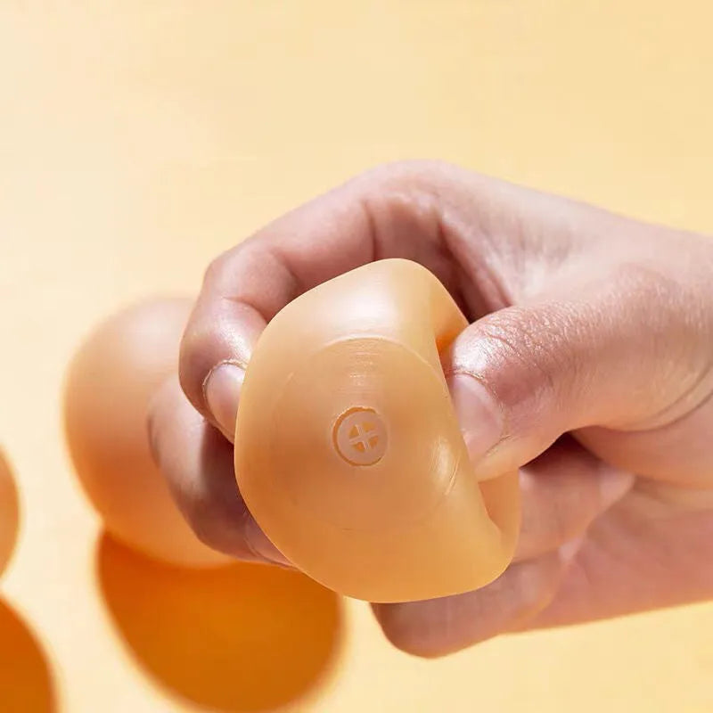 Bright coloured rubber egg-shaped dog toy with textured surface for dental cleaning