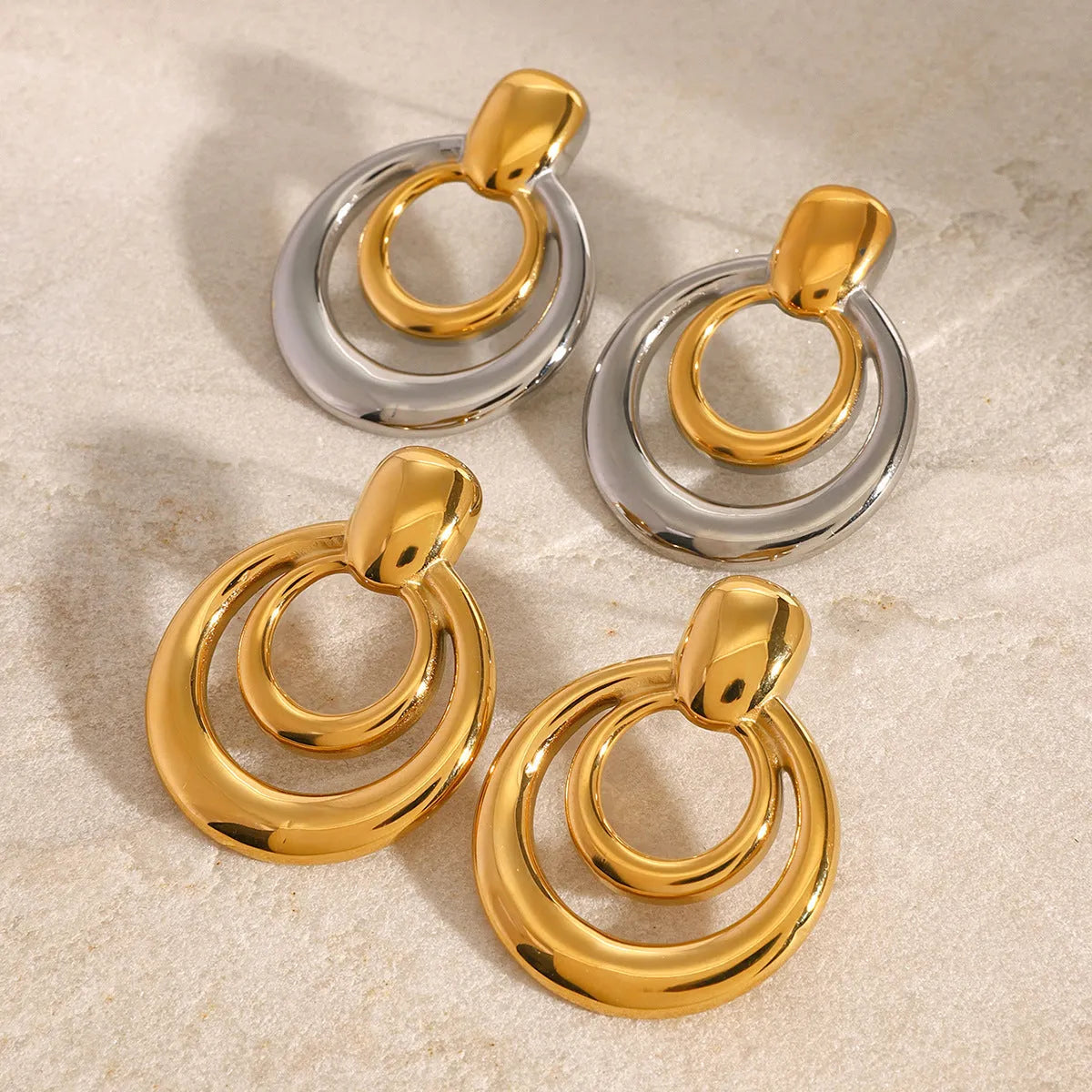 Gold plated titanium steel double layer hollow stud earrings with round geometric design