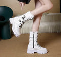 Black women's mid-calf boots with metal buckle detail and a side zip fastening.