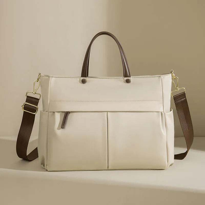 Portable oxford cloth laptop briefcase for women in elegant black with contrast stitching and large capacity.
