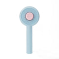 Blue self-cleaning pet grooming brush with angled metal needles and a yellow button.