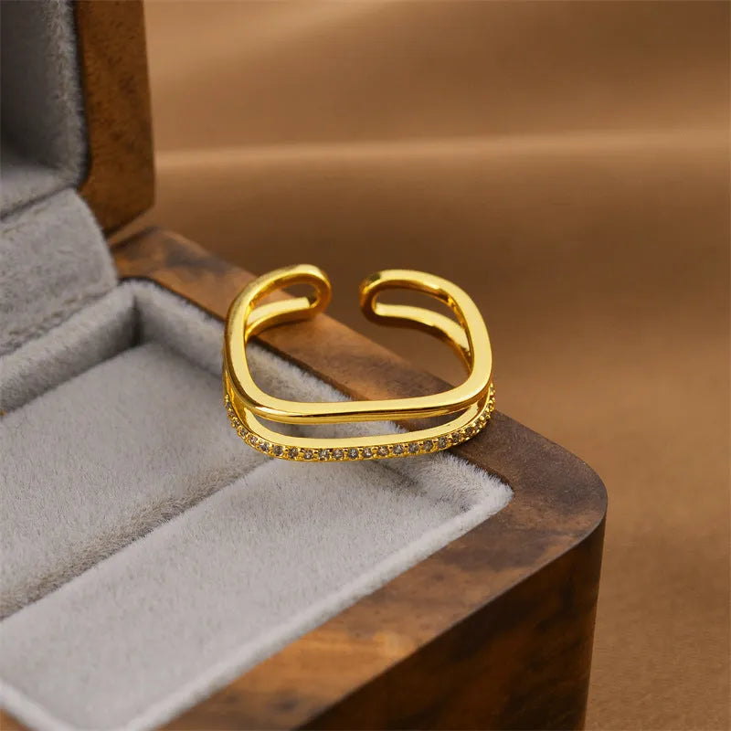 Women's geometric open ring in electroplated gold colour on a copper base.