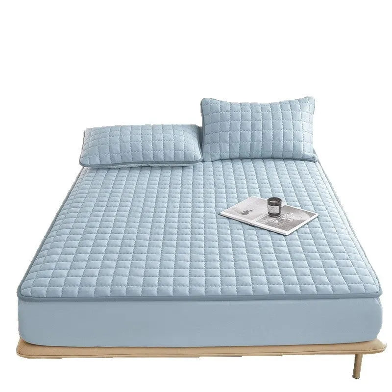 Blue washed cotton waterproof fitted sheet with elasticated corners shown on mattress
