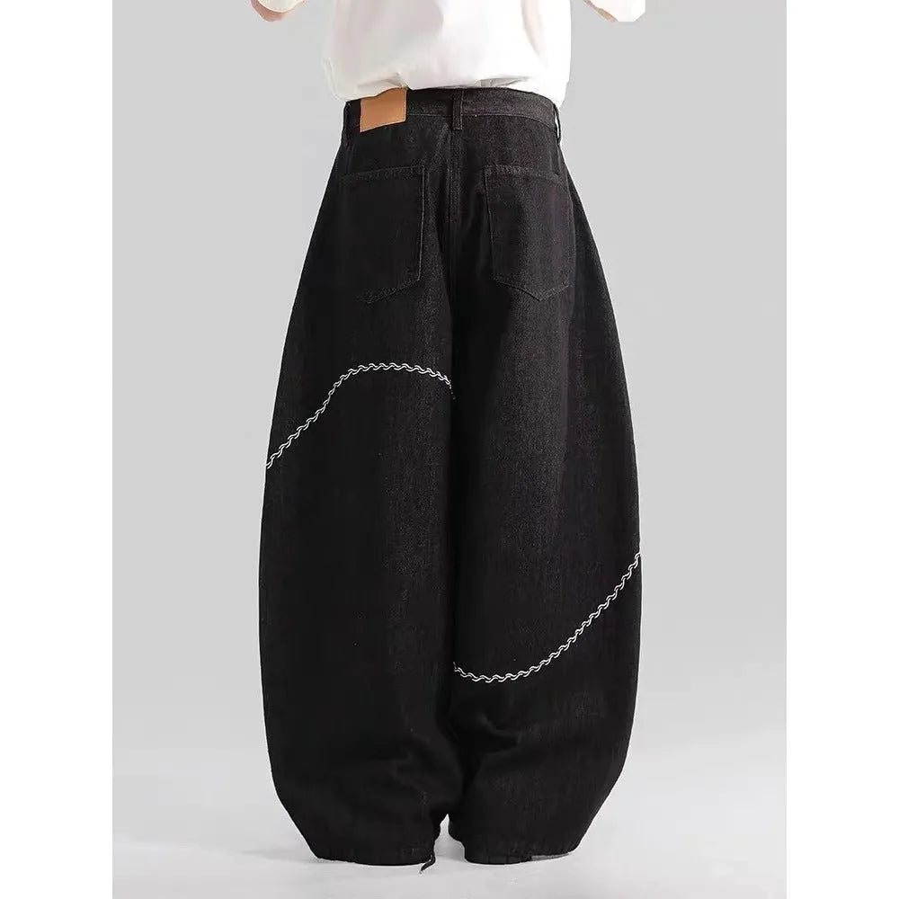Black straight-leg men's trousers with a mid waist and zip fly, made from micro-elastic denim.