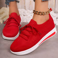 Women's low-top fly-knit sneakers in black, blue, or red with round toe and lace-up front.