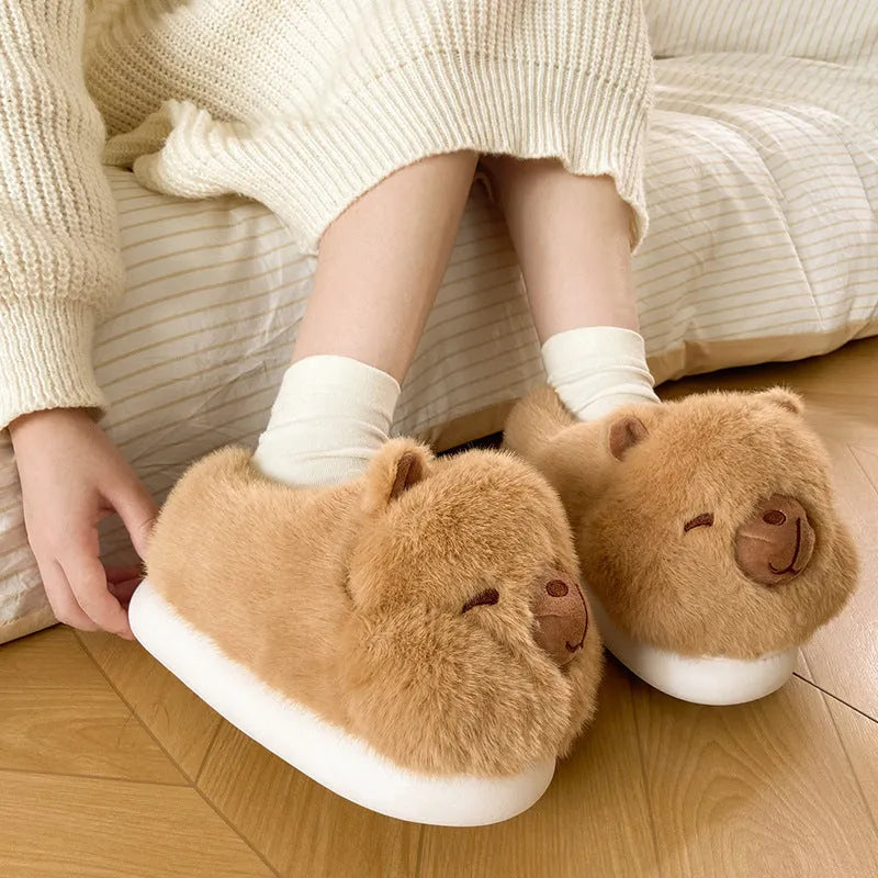 Light brown women's plush winter slippers with cartoon pattern and artificial wool lining.
