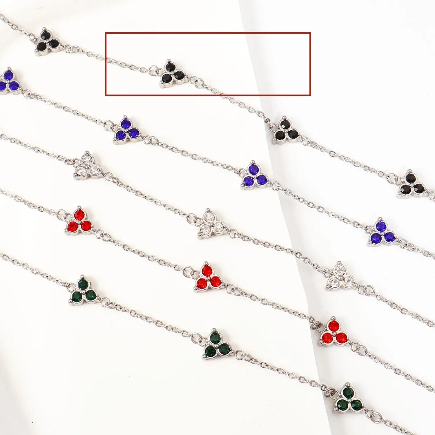 Women's stainless steel geometric triangle bracelet with a three-diamond pattern, shown in a gold and white zircon colour option.
