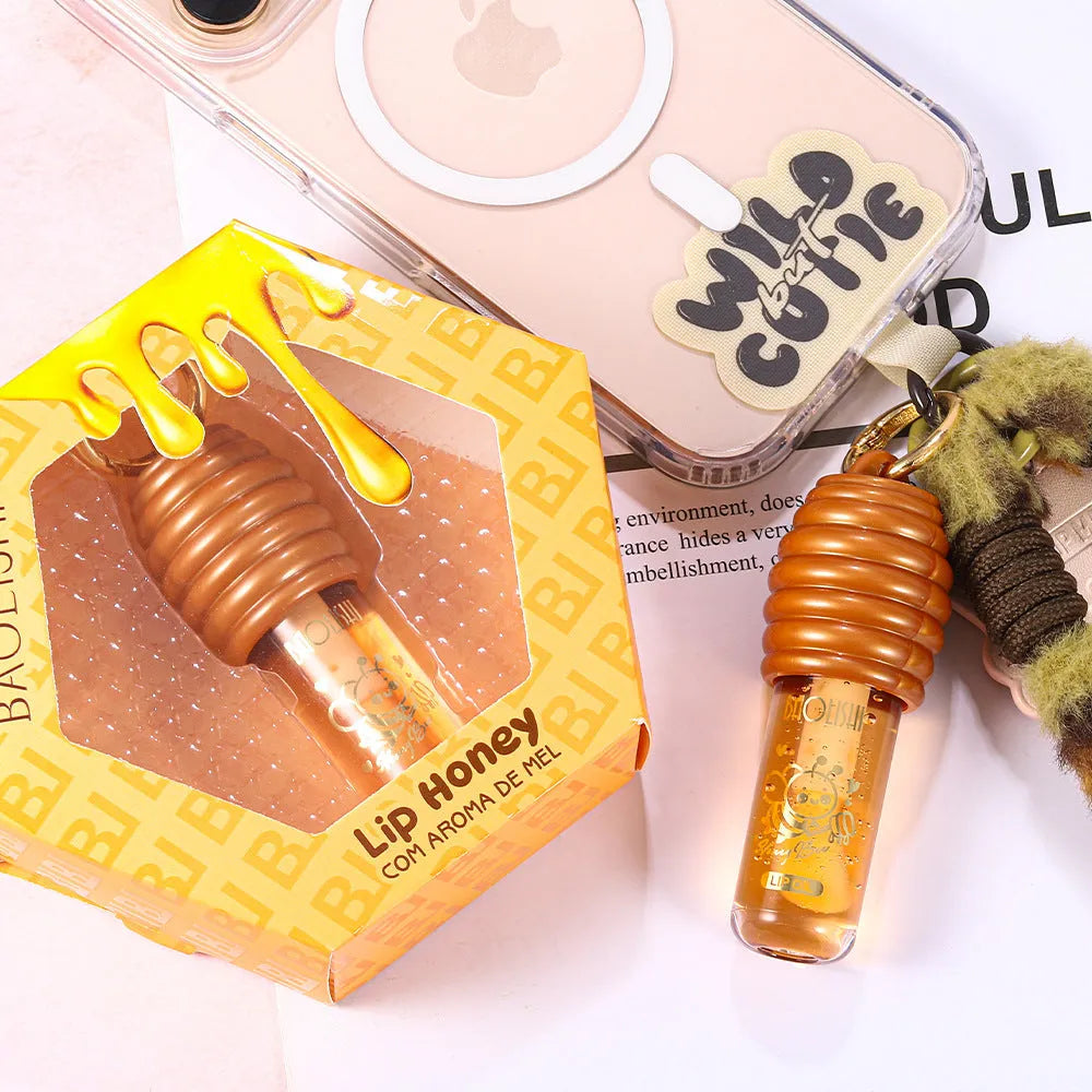 Honey Lip Gloss in a portable keychain case for moisturising and nourishing lips.