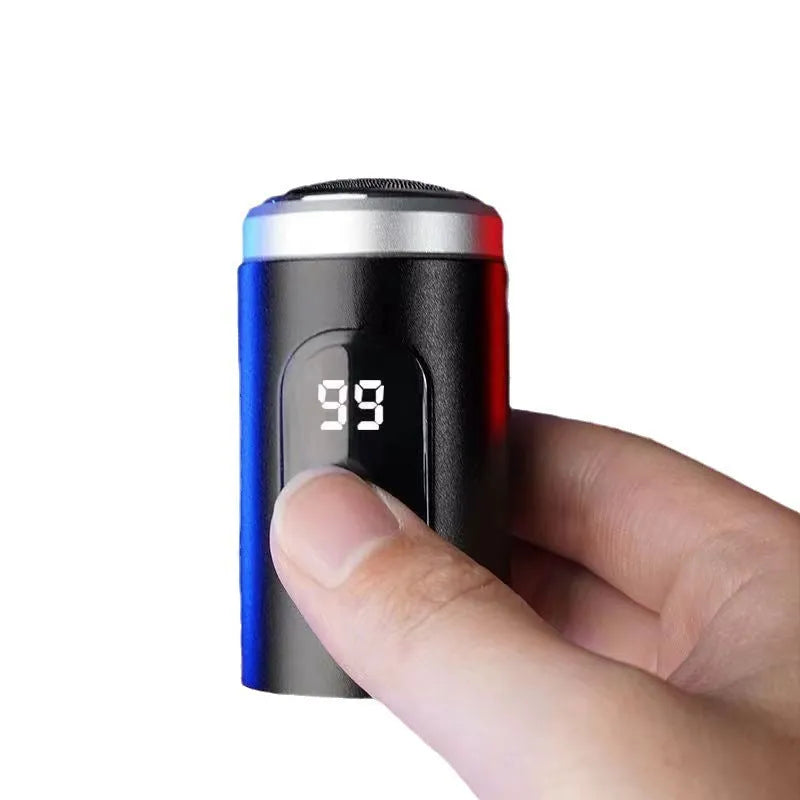 Black mini portable USB rechargeable electric shaver with cleaning brush and cable.