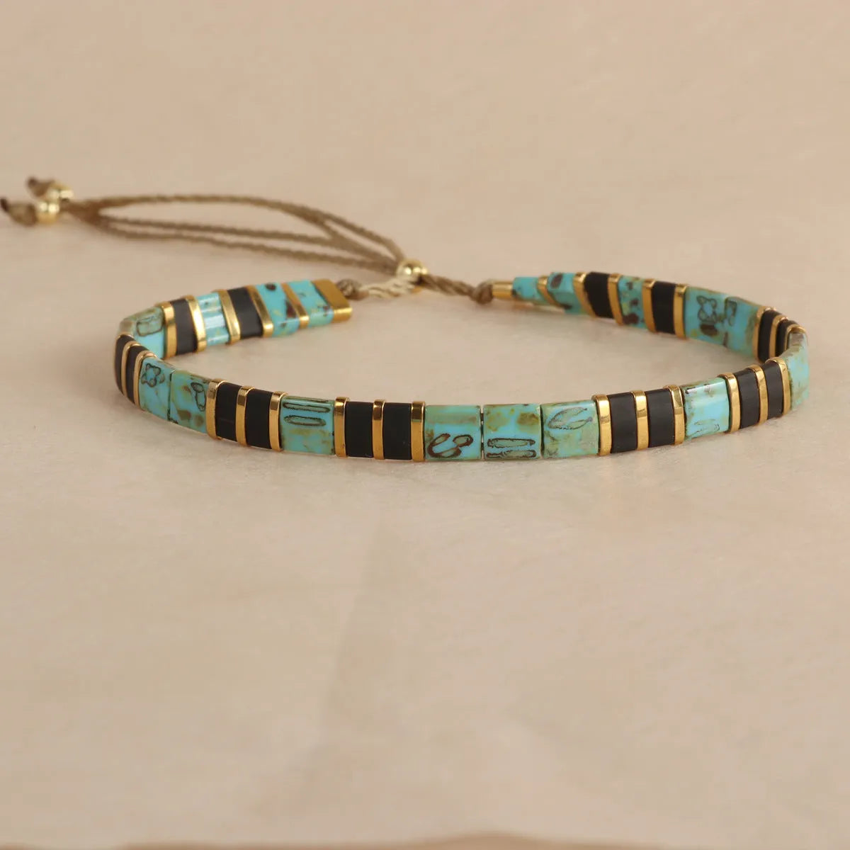 Geometric beaded pull-on bracelet in milky white, black, green, blue, or red colours