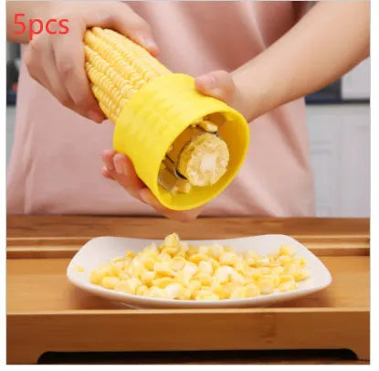 Yellow corn-shaped manual kitchen thresher for peeling corn kernels.