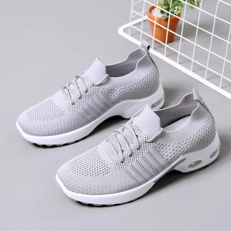 Women's black mesh casual sneakers with round toe and white lace-up front on a soft non-slip sole.