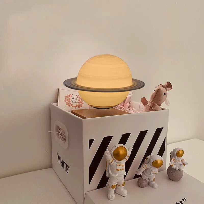 Floating magnetic levitation moon planet lamp with LED light and astronaut figures on desk