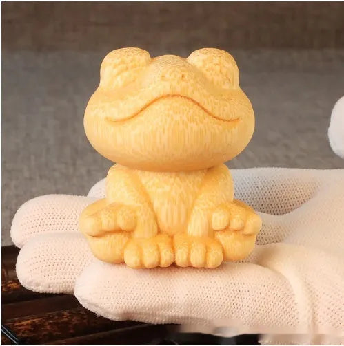 Small smiling frog ornament carved from solid bamboo measuring 5cm in height
