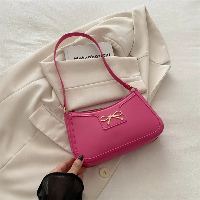 Western style PU leather shoulder bag with bow detail in horizontal square shape.