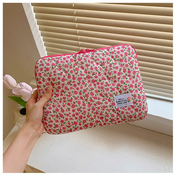 Floral print cloth laptop bag showing green flower pattern with storage compartments and anti-seismic protection