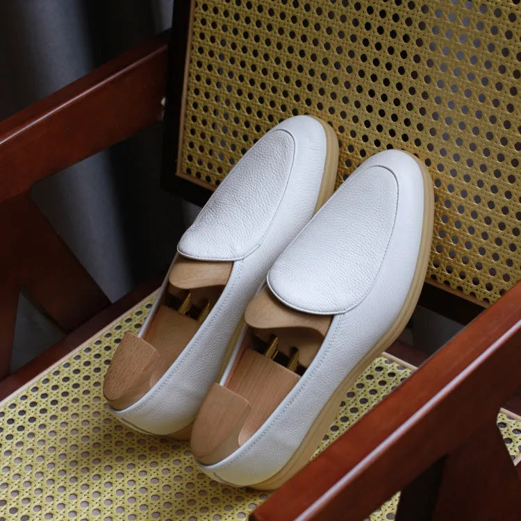 Men's brown genuine leather loafers with a TPR sole on a white background.