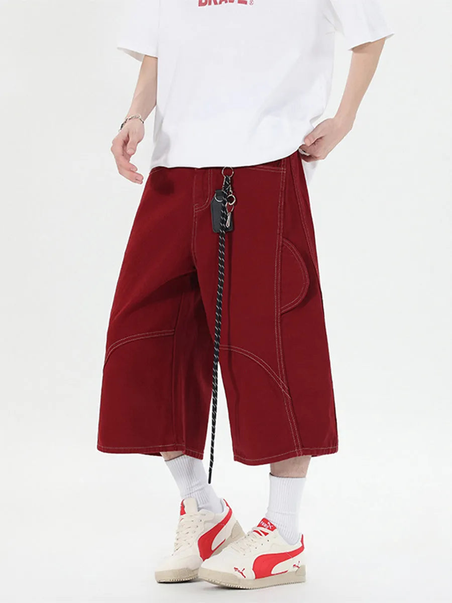 Red retro denim shorts with wide leg and multiple pockets laid flat.