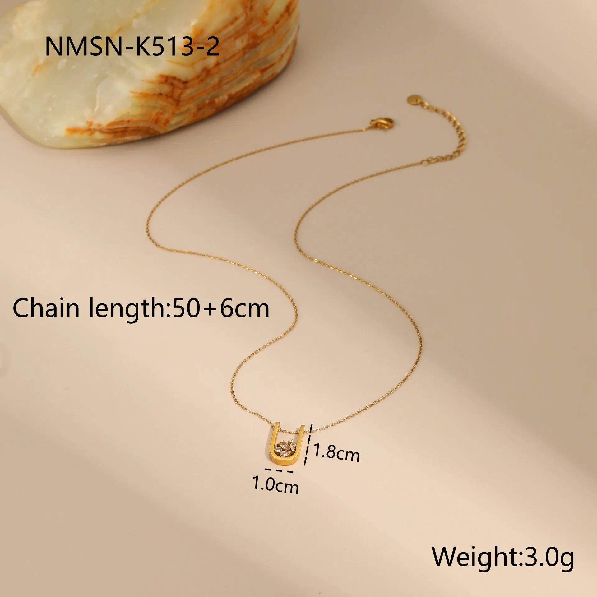 Geometric gold-plated jewellery set showing necklace, ring, and earrings on stainless steel with 18K plating