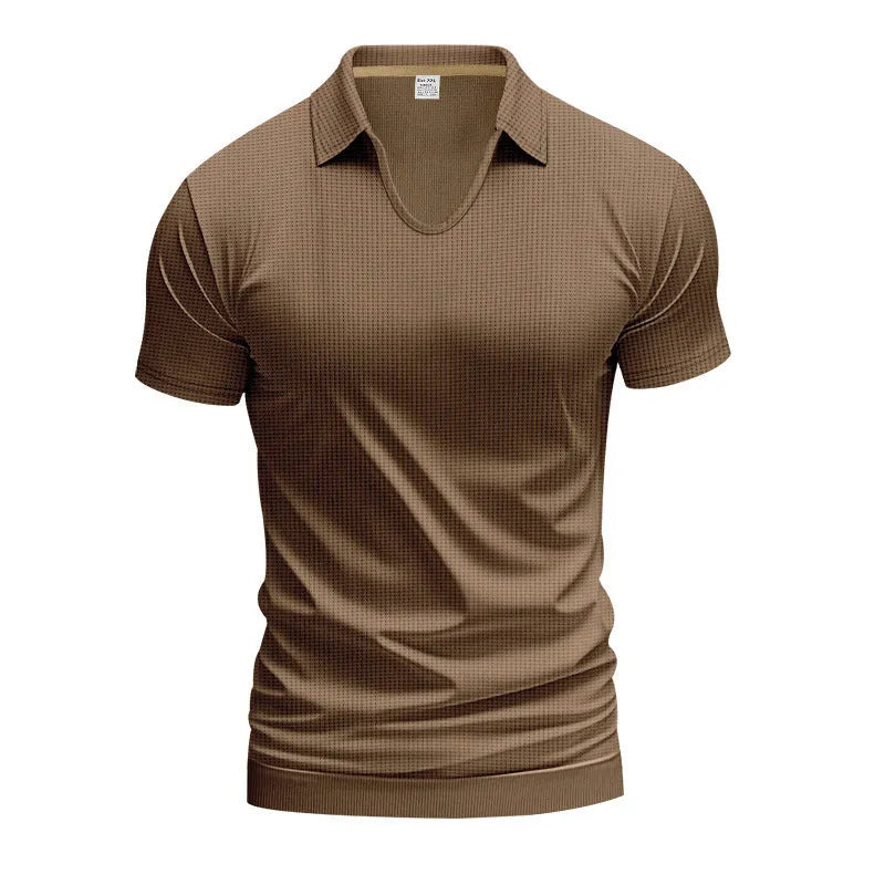 Man wearing a loose-fit apricot coloured V-neck short sleeve cotton blend T-shirt.