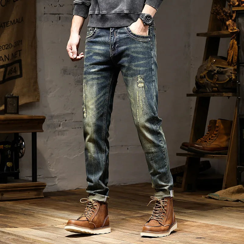 Man wearing skinny fit retro blue jeans with a zip fly, showcasing the casual pencil pants style.
