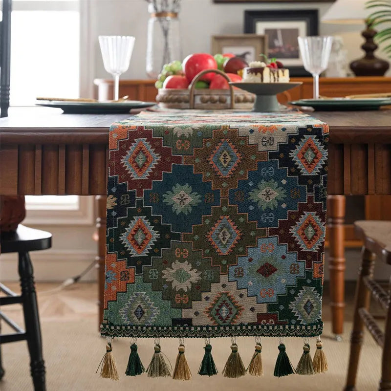 Dark blue striped Nordic jacquard bouquet table runner with tassel trim laid flat on a table.