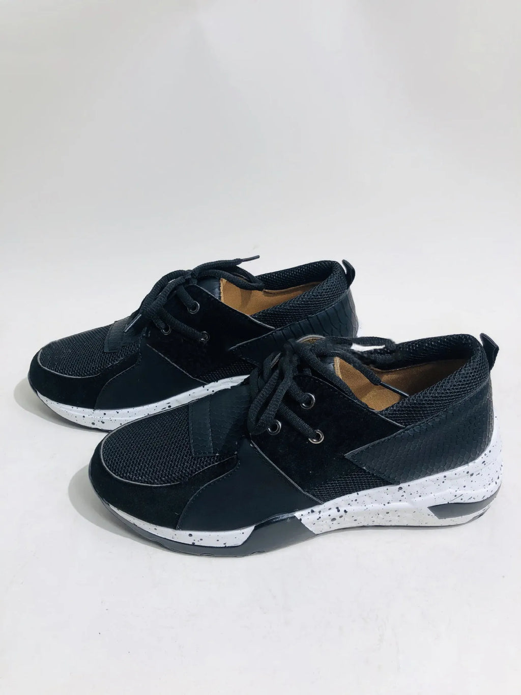 Women's casual suede sneakers with a wedge heel in various colours including black, pink, and leopard print.