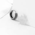 Silver geometric earrings with retro twist design and striped detailing on circular stainless steel form