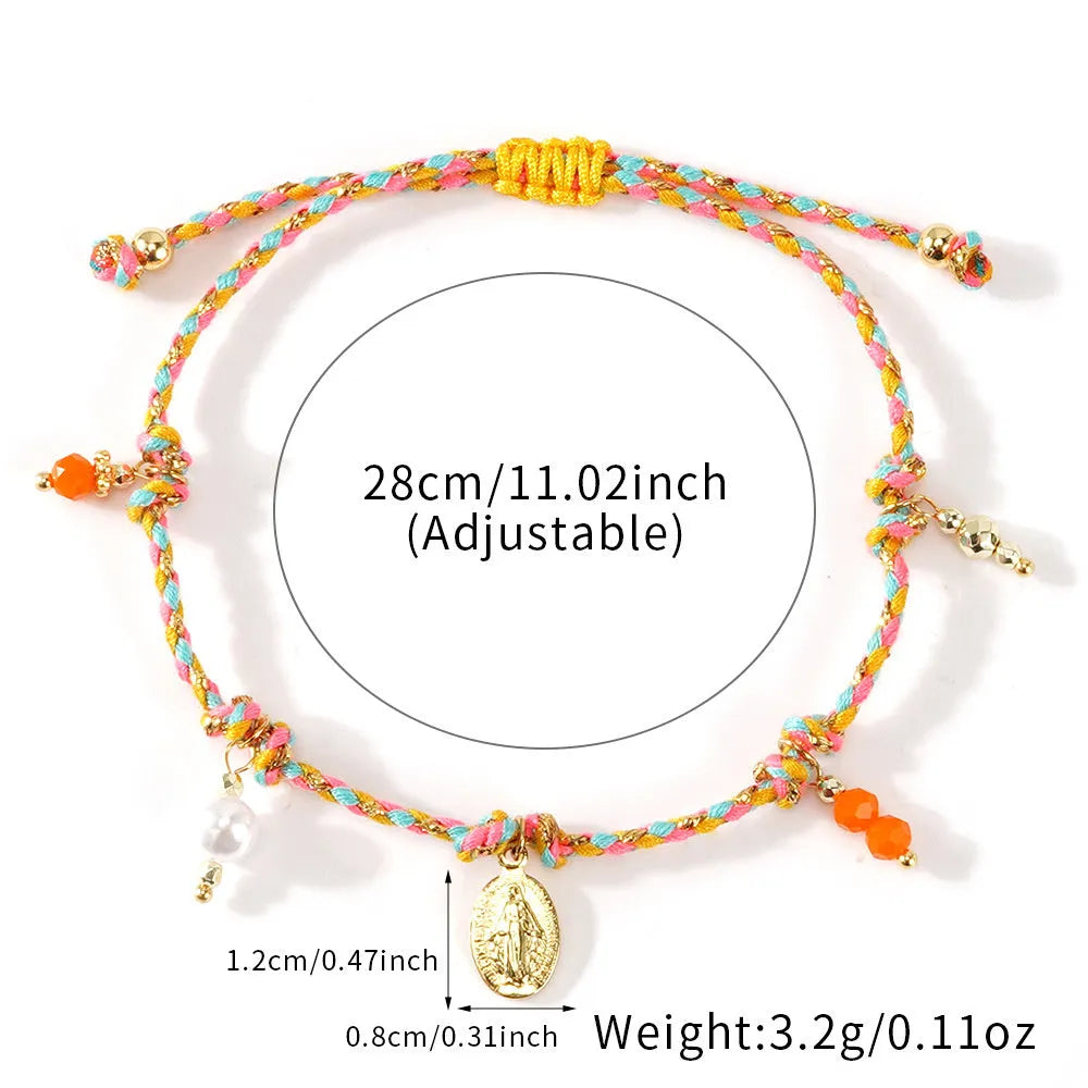 Close-up of a woman's hand-woven colourful braided rope bracelet with an adjustable strap tag.