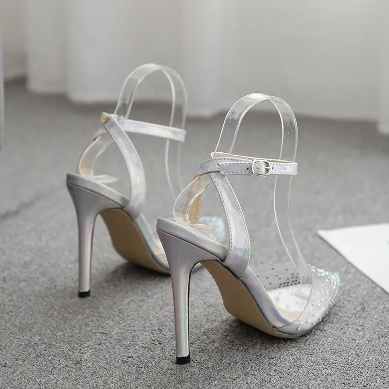 Women's pointed toe diamond sandals with a clear stiletto heel on a white background.