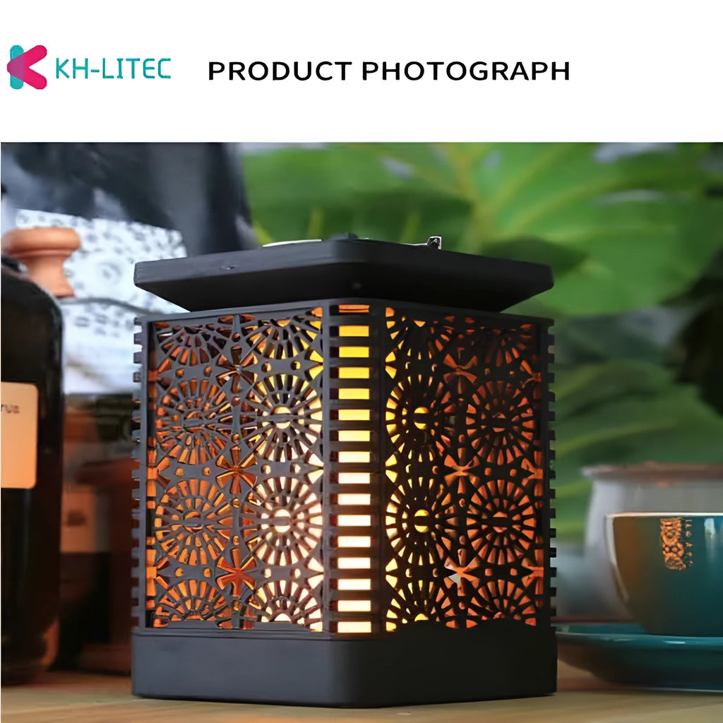 Black solar-powered hanging lantern with flickering LED flame light effect for garden decoration.