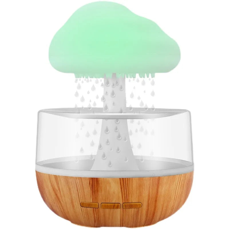 White raining cloud humidifier with night light and essential oil diffuser on table