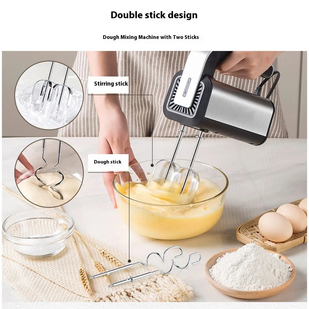 Silver handheld electric kitchen whisk with mixing attachments on counter
